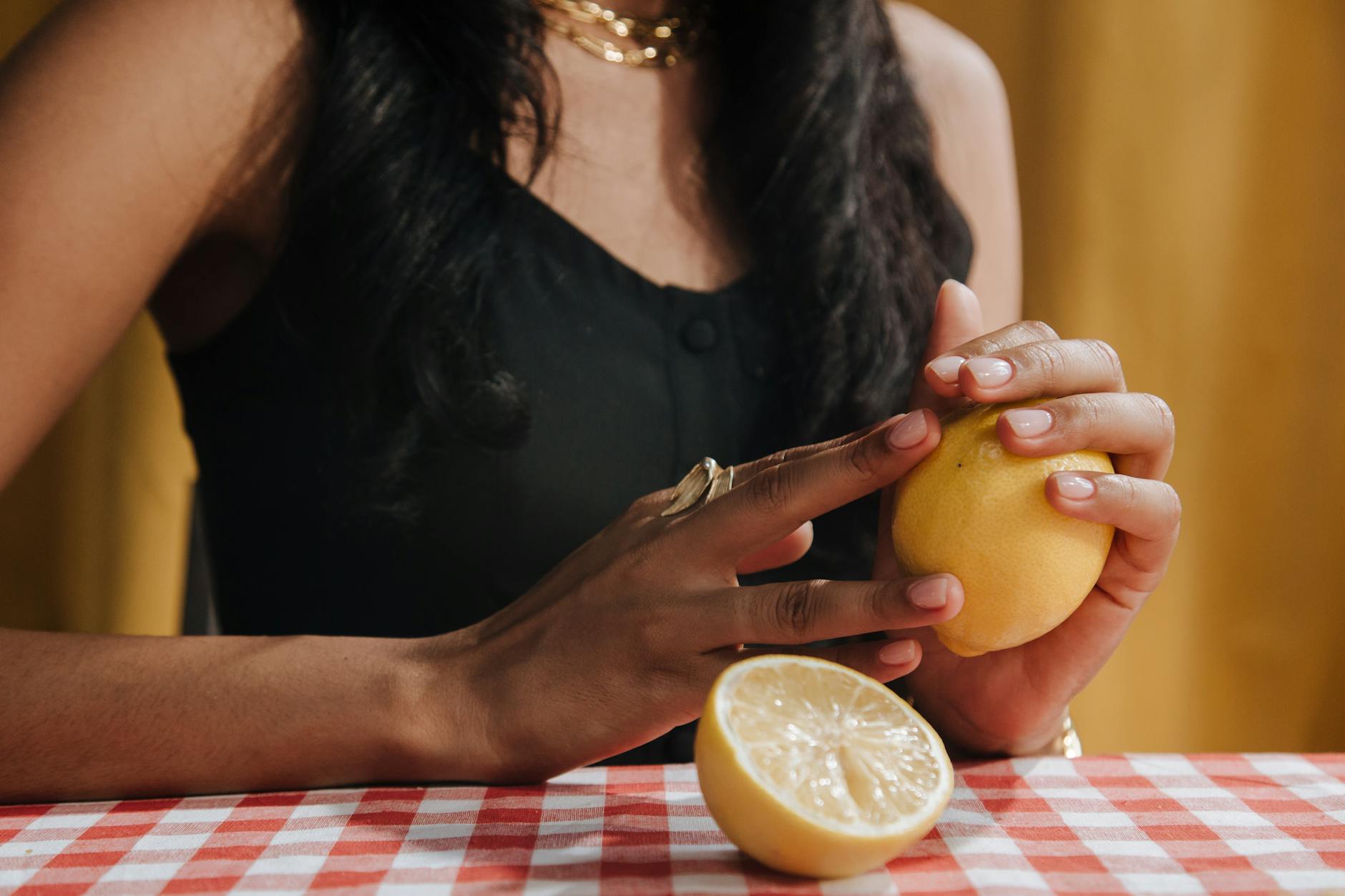 Hands holding a blue vibrator against a purple background, demonstrating intimate control and touch